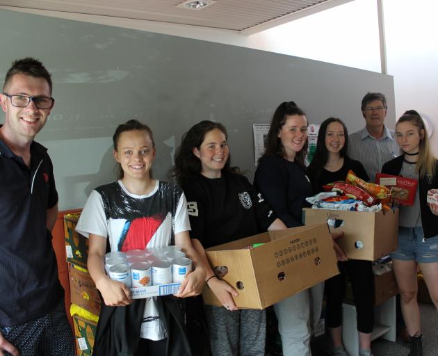 Salvation Army foodbank co-ordinator Peter Lobb (left)  with Otago Girls’ High School pupils ...