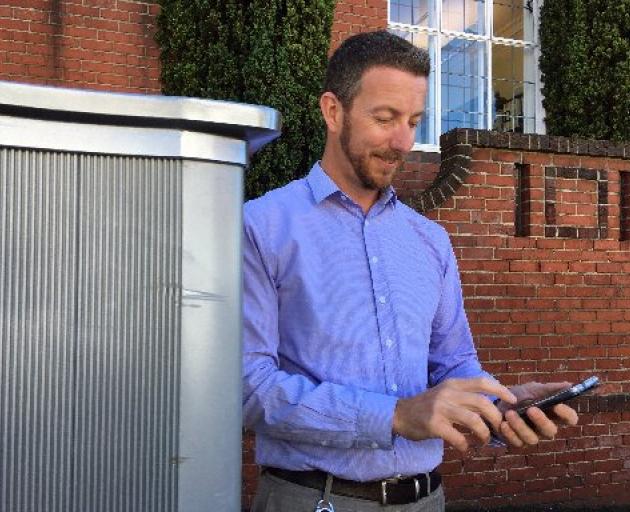 Dunedin City Council parking operations team leader Reece Smith uses the ‘‘Pay My Park’’ app on...