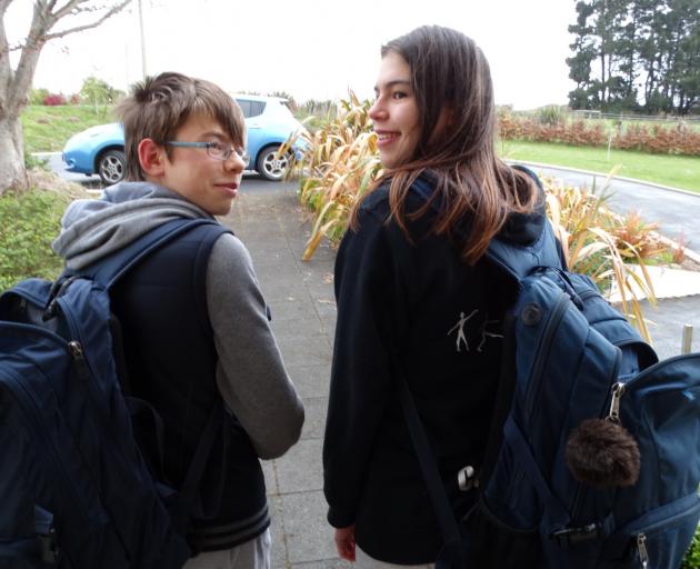 Dunedin teenagers Marcus (left) and Catherine Davidson (18) display the large and heavy backpacks...