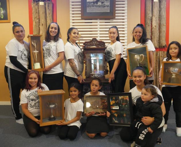 Te Huinga Rangatahi O Nga Hau E Wha members hold the netball, marching and kapa haka
...