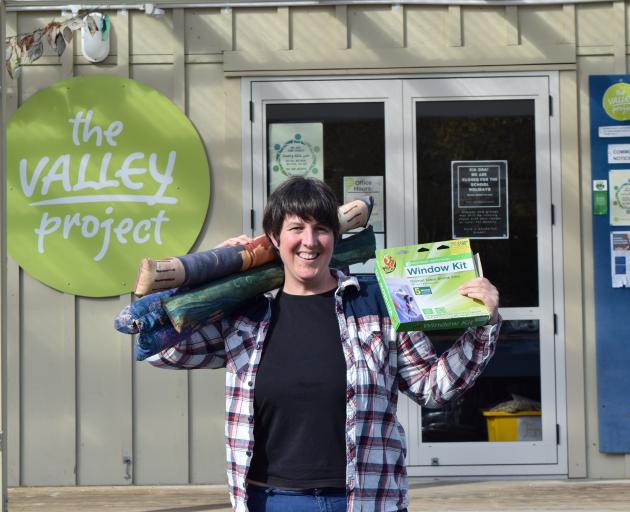 The Valley Project community worker Charlotte Wilson displays draught stoppers and window film to...