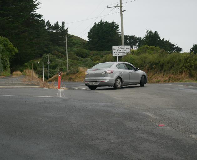 The driver of a rental car crosses the centre line while turning left from Camp Rd into Highcliff...