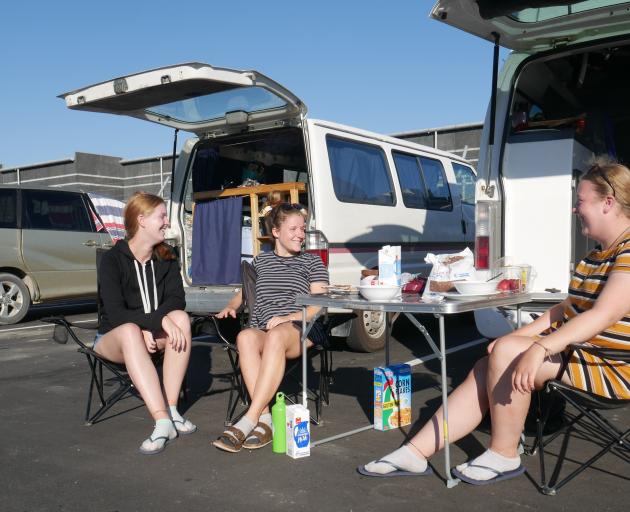 Freedom campers (from left) Janice Lohs, Anne Schmautz and Christin Firchow eat their breakfast...