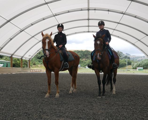 Riding in the covered arena  at Riding for the Disabled last week are Evie Auchinvole (12, left),...