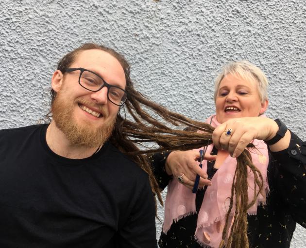 Maggie Garden wields scissors on the dreadlocks of her son, Chris Millar, in Dunedin. PHOTO:...