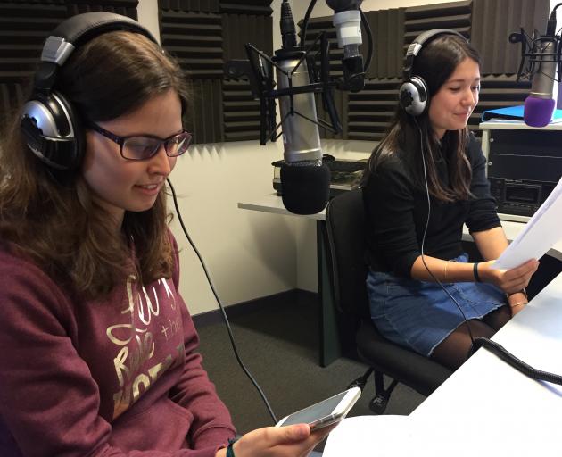 French exchange students Chloe Parfait (16, left) and Clara Mannes (15) create their radio show...