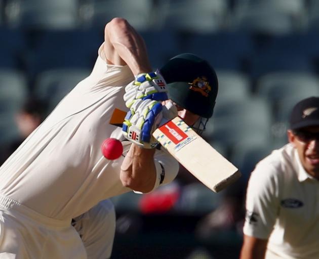 New Zealand's Ross Taylor watches as Australia's Shaun Marsh sends the pink ball to the boundary at the Adelaide Oval. Photo: Reuters 