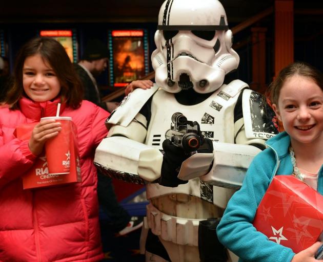 Ngaio (left) and Kiriana Davidson-Duell with Star Wars storm trooper Warren Goodwin during the Star Wars Marathon at the Rialto in Dunedin yesterday.  Photo by Peter McIntosh.