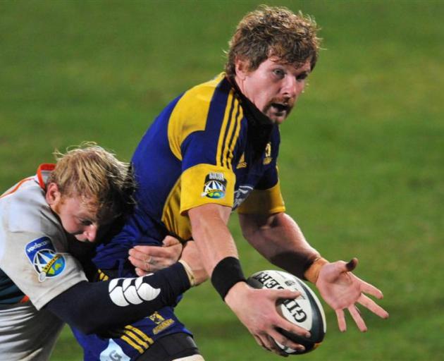 Highlanders blindside flanker Adam Thomson is tackled by Cheetahs hooker Adriaan Strauss during...