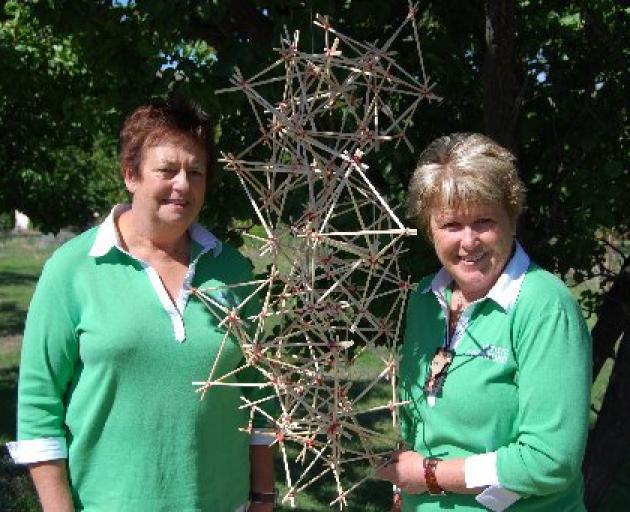 Changing form: Rhonda Hall and Rae Baxter, of Winton with one of the works created by the 40 people who took part in two floral art seminars in Bannockburn.