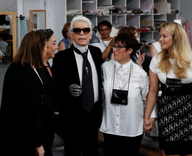 Karl Lagerfeld (centre) appeared at the end of the show with some of the atelier's seamstresses. Photo: Reuters 