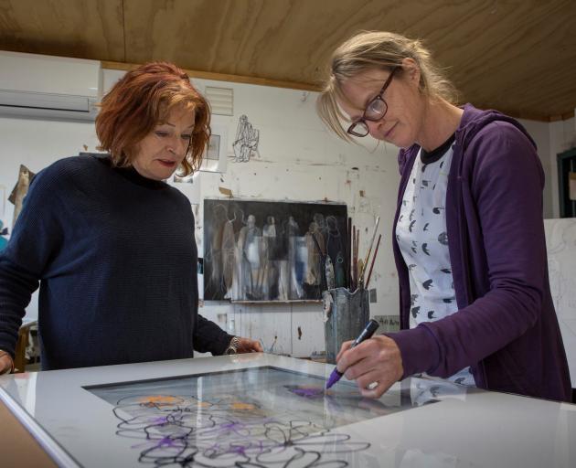 Hullabaloo member Gail de Jong (left) watches past member Odelle Morshuis prepare work for the...