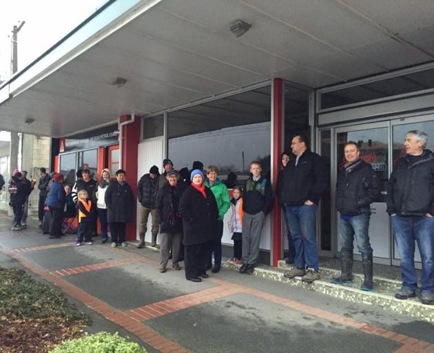 West Otago residents line up on Northumberland St in Tapanui as they wait to get their hands on movie tickets to Pete's Dragon, which will be screened next week. Photo from Ideal Print.