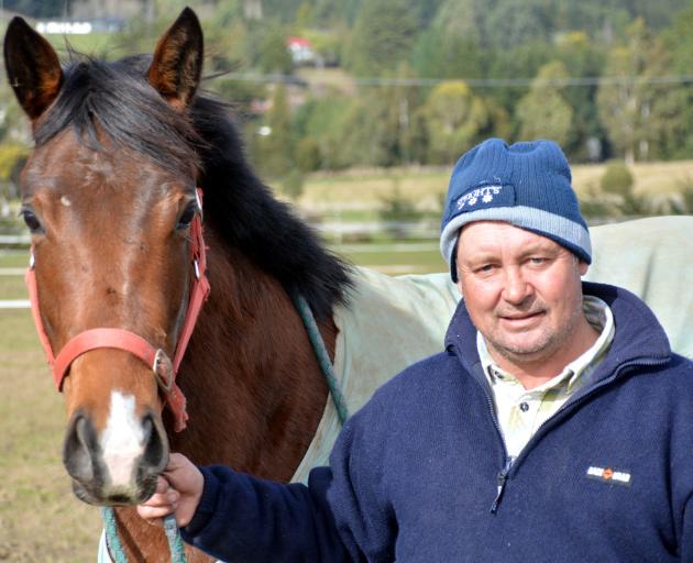 Wingatui trainer Terry Kennedy with a 2yr-old Rock 'n' Pop-Read My Lips filly at his stables on Wingatui Road yesterday. Photo by Matt Smith.