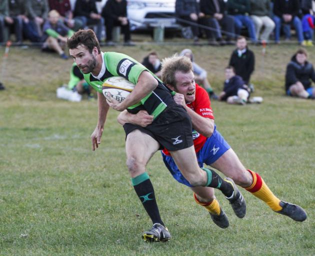 Maheno midfield back Craig Smith is tackled by Kurow’s Craig Robson during a Citizens Shield club...