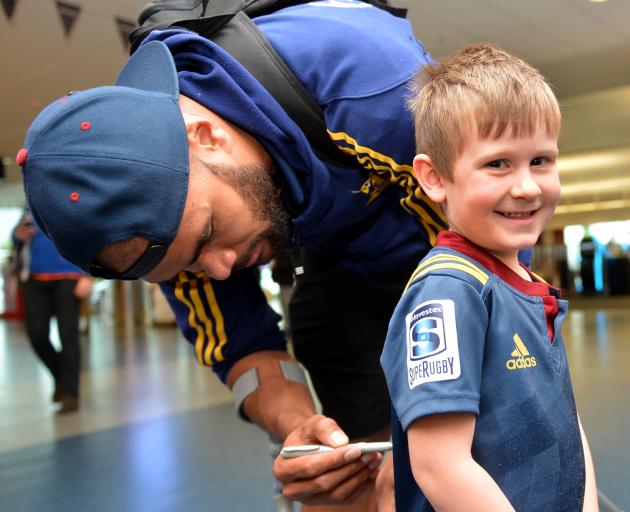 Young Highlanders fan Beau Glover (4) gets his jersey signed by winger Patrick Osborne at Dunedin International Airport yesterday. Photo by Stephen Jaquiery.