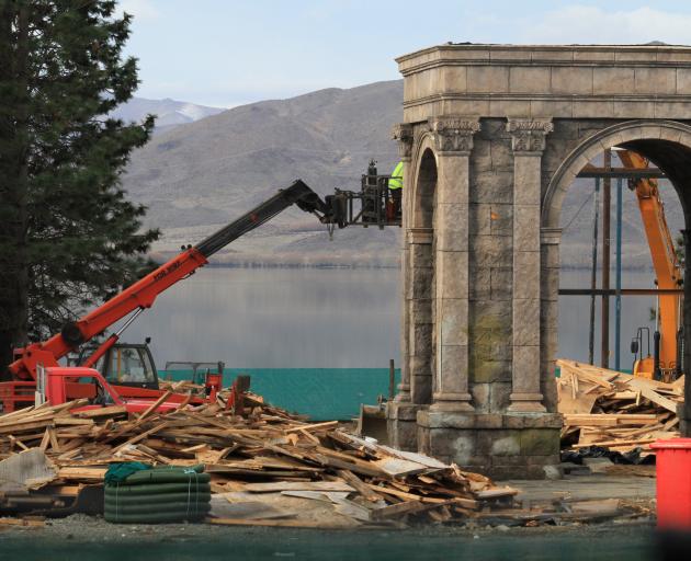 What was to be a Sea of Galilee fishing village and harbour at Falstone Camp is demolished by Paul Smith Earthmoving employees at Lake Benmore yesterday. Photo by Hamish MacLean.