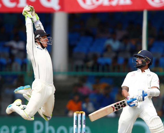 New Zealand wicketkeeper B-J Watling leaps for the ball after India's Murali Vijay avoids a...