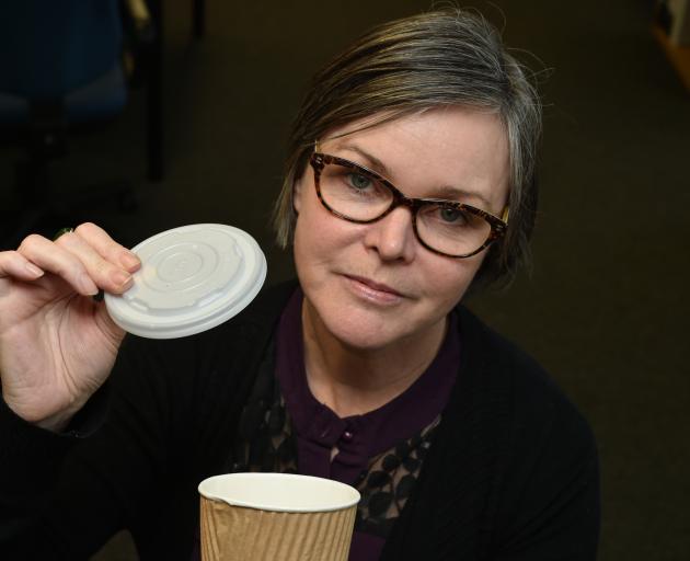 Dunedin City Council waste manager Catherine Irvine holds up a coffee cup lid which cannot be...