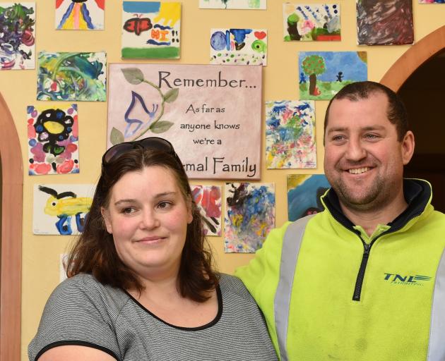 Errol and Rebecca Bain in their South Dunedin home yesterday with paintings by their foster...
