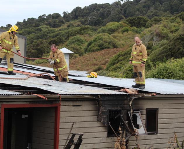 Firefighters from Bluff and Invercargill check for hot spots after extinguishing a fire at the...