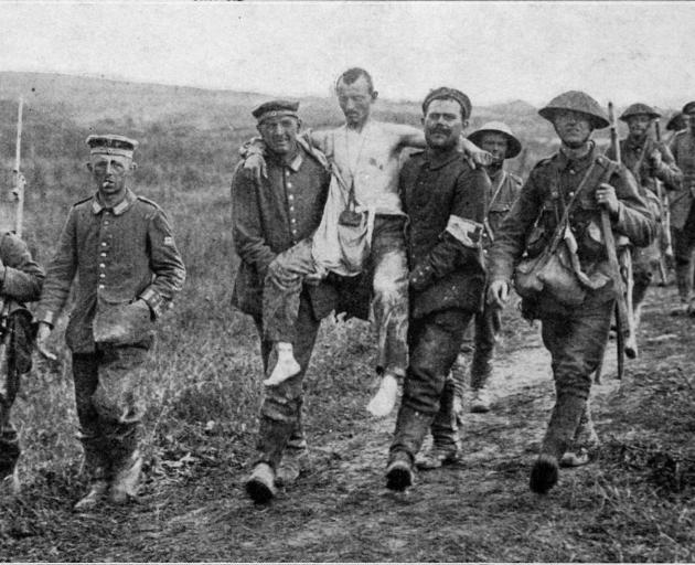 German prisoners carrying their wounded to the rear of the Allied lines in France. 