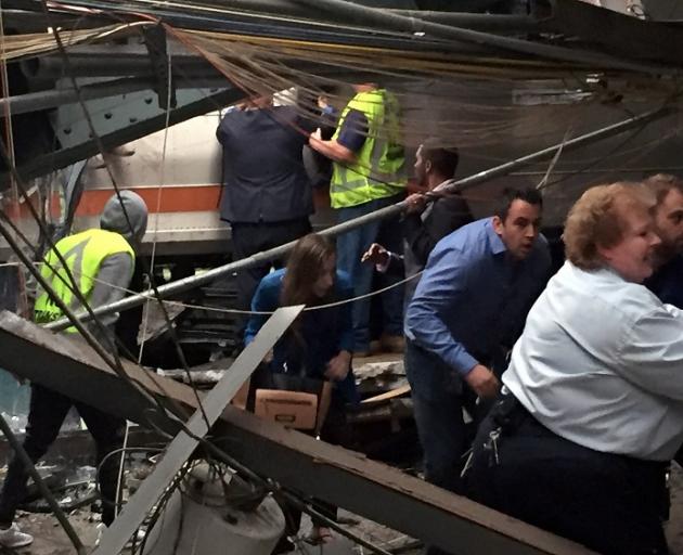 Passengers rush to safety after the train crashed in to the platform at the Hoboken station....