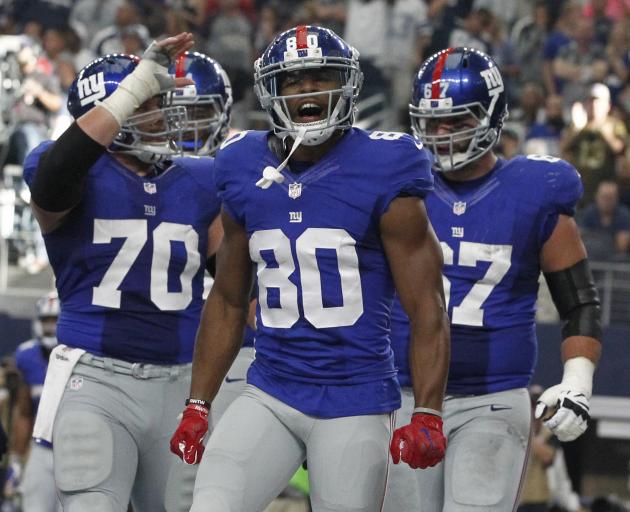  New York Giants wide receiver Victor Cruz (80) reacts after catching a touchdown pass in the...