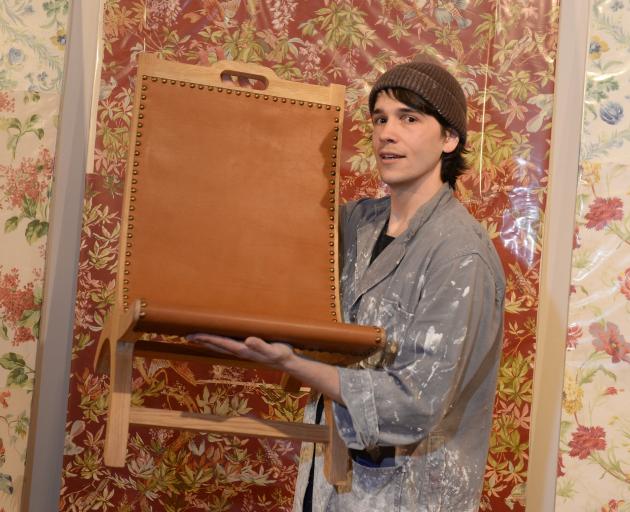 Blaine Western (27) holds a chair by Jill Magid in front of works by Zac Langdon Pole. Photos:...