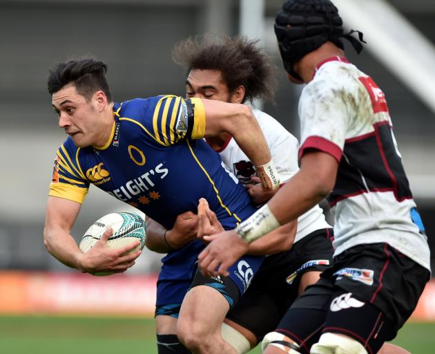 Otago halfback Jonathan Ruru tries to break through the tackle of North Harbour captain Chris Vui...