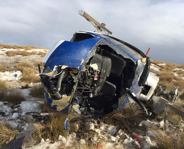 The wreckage of a helicopter that tipped over while landing on Mt Sale, on the Crown Range, on Monday. Photo from NZ Police.