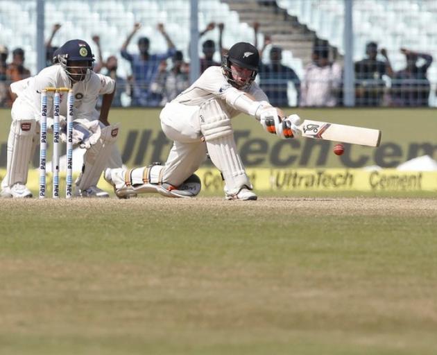 New Zealand's Tom Latham (right) plays a shot watched by India's wicket-keeper Wriddhiman Saha....
