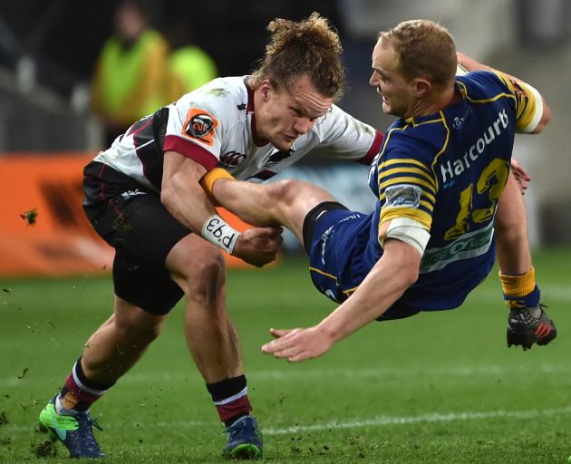 Otago centre Matt Faddes is tackled by North Harbour second five Michael Little during the Mitre...