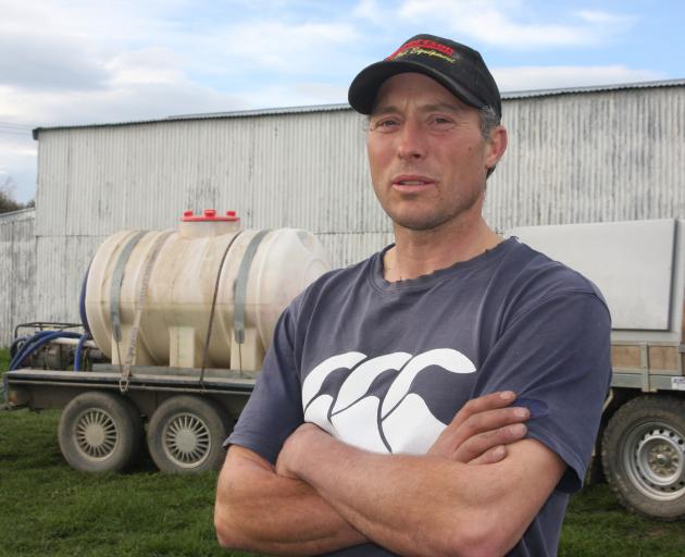 Oamaru dairy farmer Hayden Williams stands in front of his tanker. Photo by Shannon Gillies.