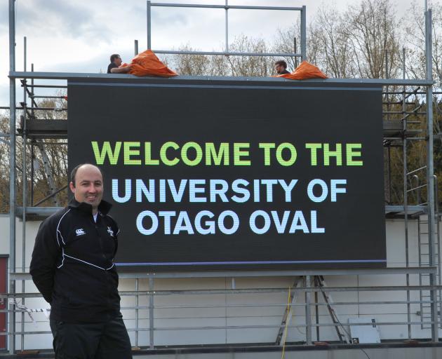 The new scoreboard at the University Oval is in place. Strawberry Sound technicans Matt Hudson ...