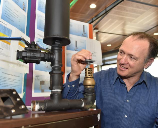 Otago Polytechnic bachelor of engineering technology student Pat Wall adjusts his hydraulic ram water pump. Photo by Gregor Richardson.