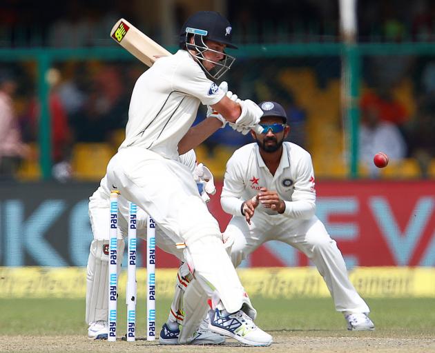 New Zealand's Mitchell Santner plays a shot during the first test match against India at Green...