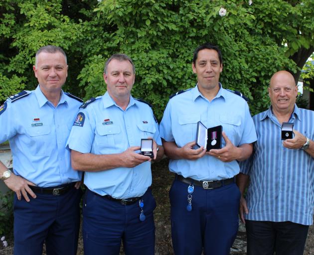 New Police Southern District Commander Inspector Paul Basham (left) presented long service awards to (from second left) Senior Sergeant Ian Kerrisk, Senior Constable Sam Williams and speed camera operator Paul Mussen at the Alexandra Police Station yester