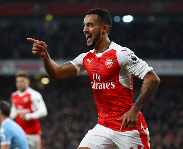 Theo Walcott of Arsenal celebrates scoring his sides first goal during the Premier League match...