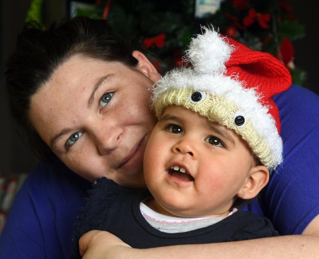 Solo mother Nicole Sparks, with daughter Harper (11 months), says it feels good to be helping to feed strangers this Christmas after she went without food this time last year. Photo by Stephen Jaquiery.