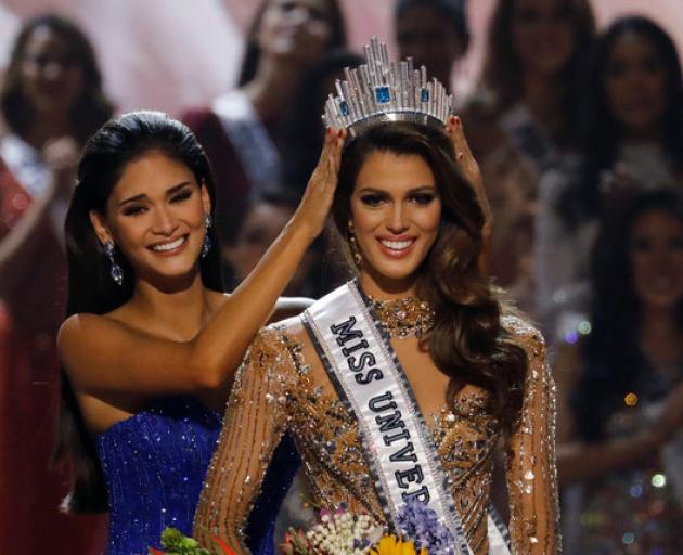 Pia Wurtzbach places the Miss Universe crown on Miss France Iris Mittenaere after the latter was...