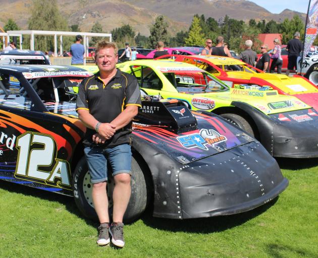 Central Motor Speedway promoter Graham Williamson with a line of super saloon cars in Cromwell. Photo by Jono Edwards.