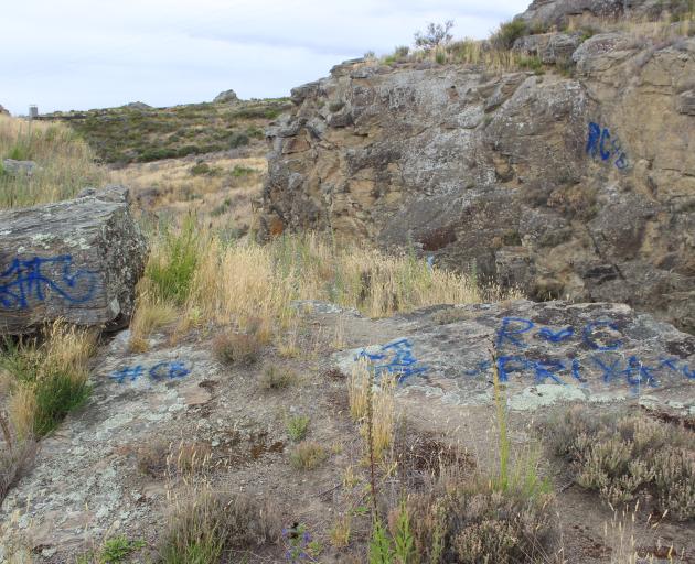 A series of tags scrawled on rocks at the entrance to Ophir. Photo by Jono Edwards.