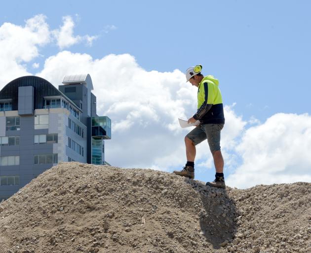Cook Brothers Construction site foreman Scott Milne checks plans at the former Wickliffe Press...