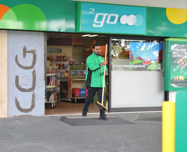 BP 2Go Oval service station attendant Anmol Singh begins the clean-up after a ram-raid yesterday morning. Photo by Christine O'Connor.