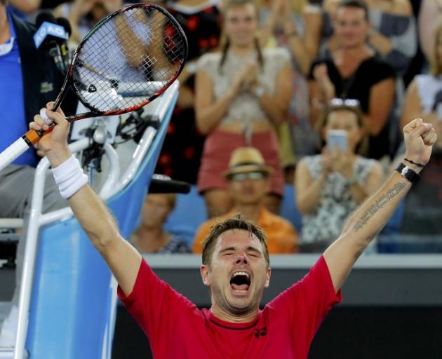 Stan Wawrinka celebrates after having to fight through the first round at the Australian Open....