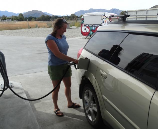 Rebecca Kirby-Crowe takes advantage of cheaper fuel at the McKeown fuel station in Wanaka. Photo by Kerrie Waterworth.