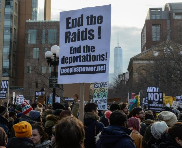 People participate in a protest against U.S. President Donald Trump's immigration policy and the...