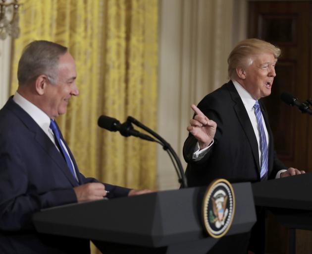 US President Donald Trump (R) shares a laugh with Israeli Prime Minister Benjamin Netanyahu at a...