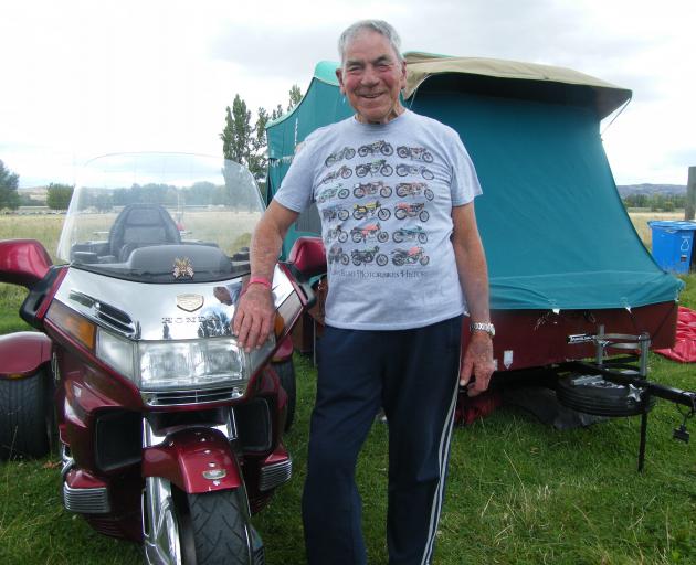 Graham Logan, of Dunedin, shows off his 1998 Honda Gold Wing trike in front of his trailer awning...